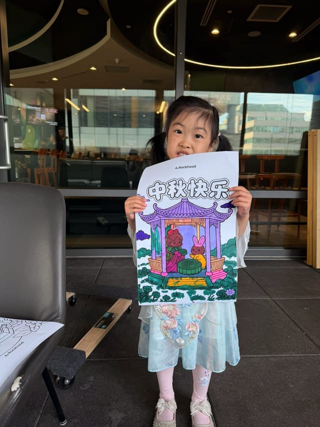 A young guest with her hand-colored Mid-Autumn artwork